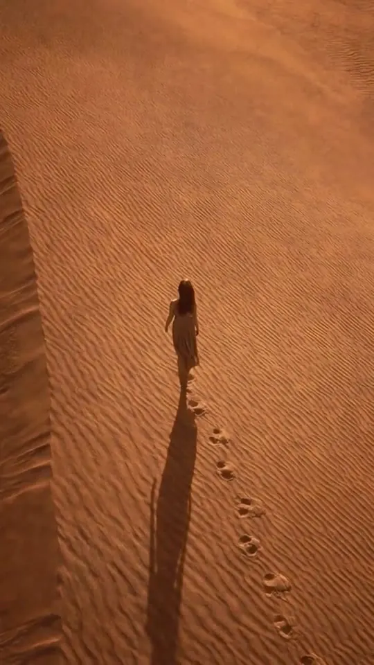 Essentia Eclipse: una mujer camina por las dunas del desierto